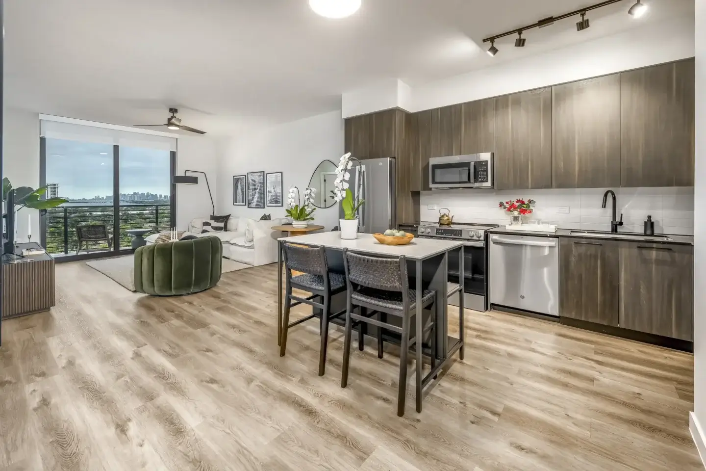 A sophisticated open-concept kitchen and living area at Biscayne Shores, showcasing premium finishes and an effortless flow toward floor-to-ceiling bay views.